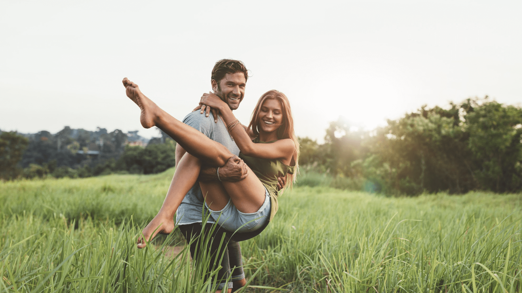 man holding woman in field